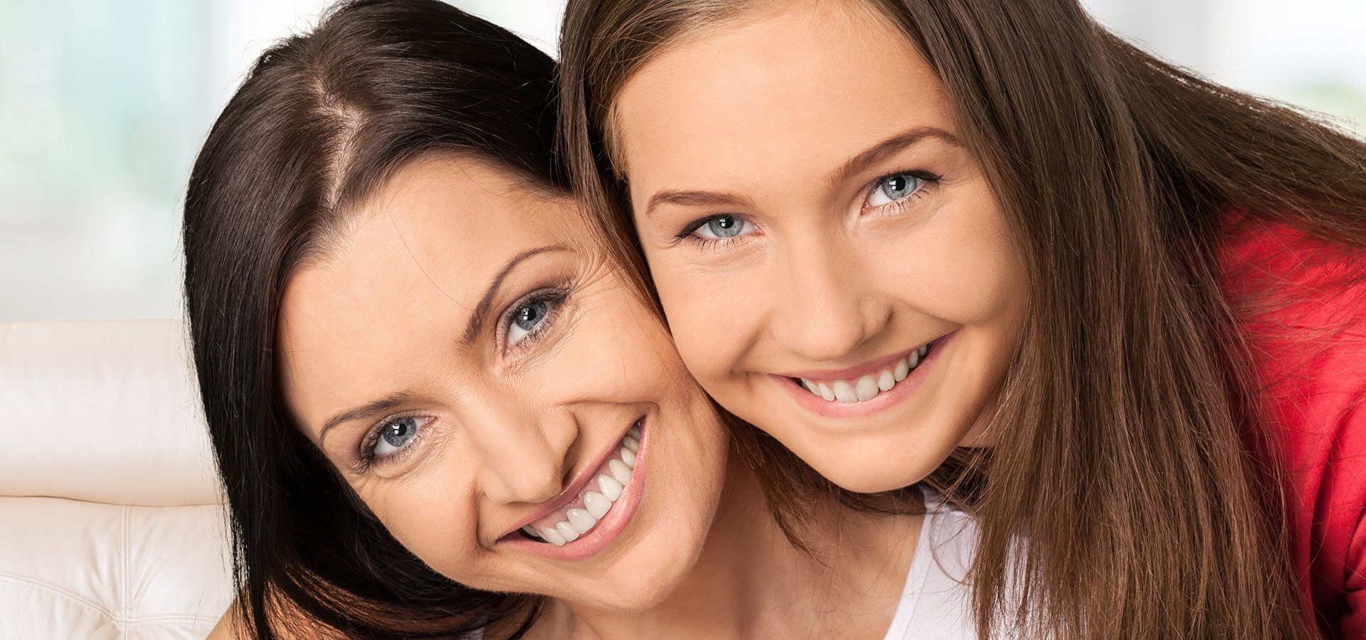 Happy mom and daughter with white teeth